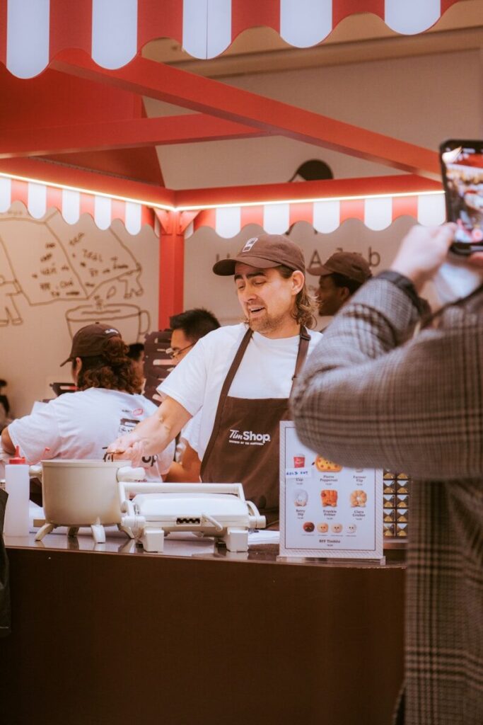 Man working at a food stand preparing food